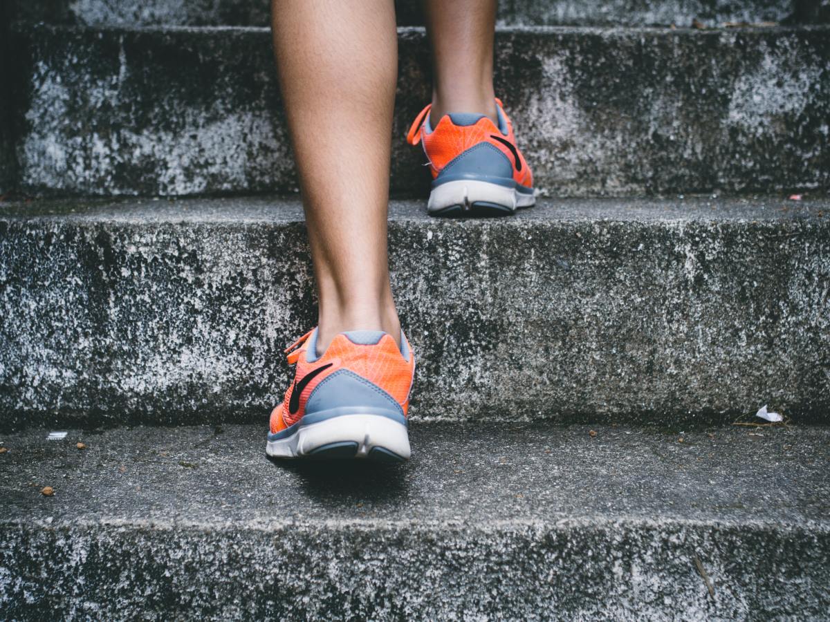5 Quick Ways to Live a Healthier Life Girl running up stairs outdoors in orange nike sneakers